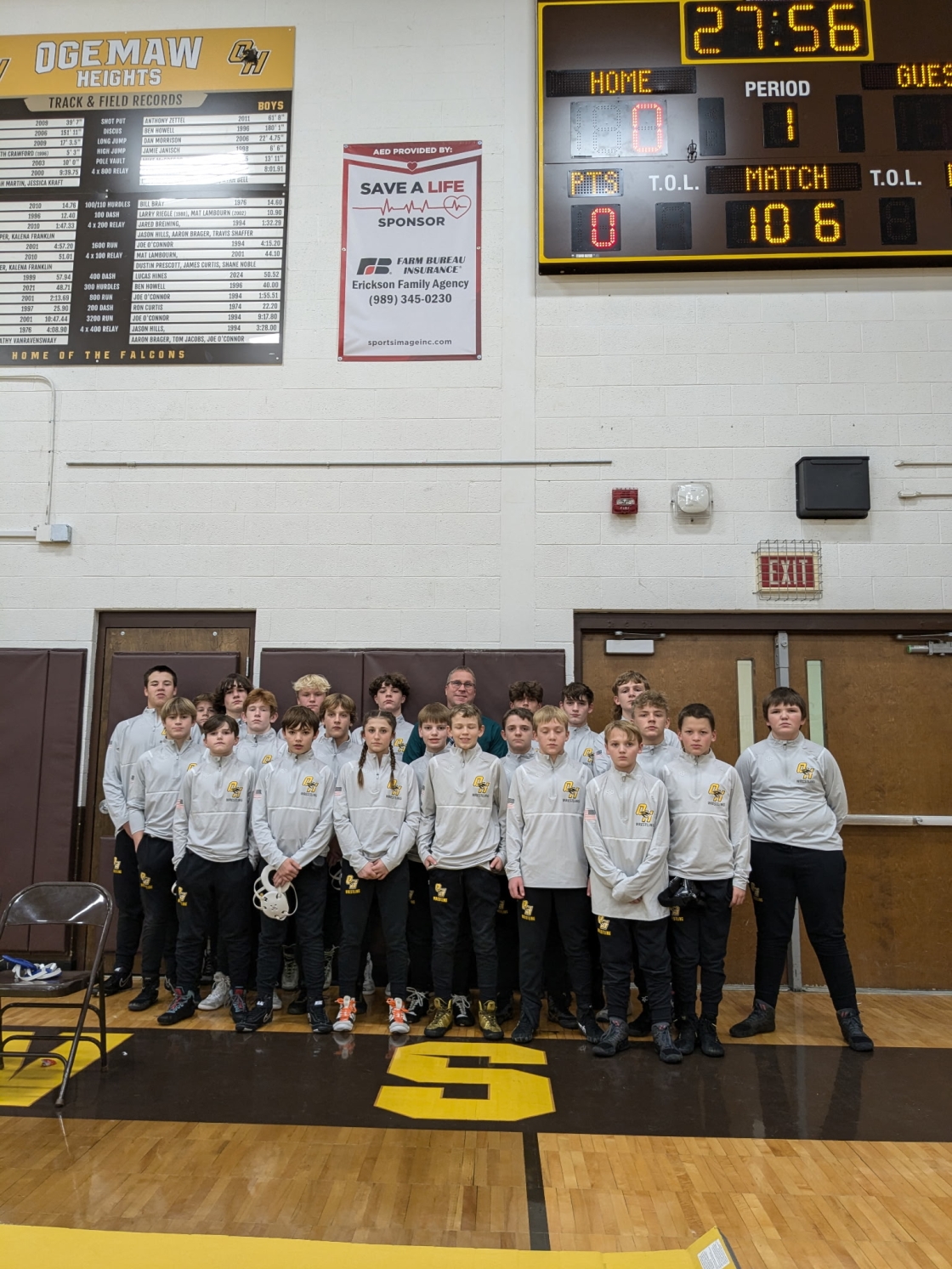 group of kids in front of scoreboard