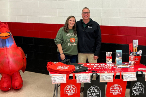 Man and women standing at a table